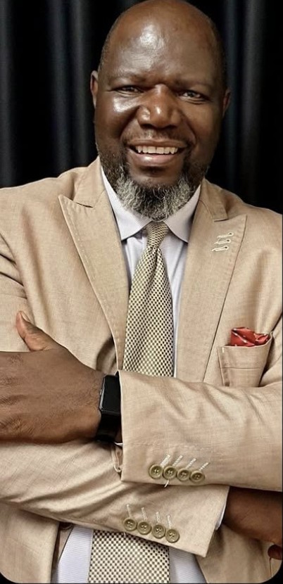 Apostle Theo Mkhabela, smiling with arms crossed